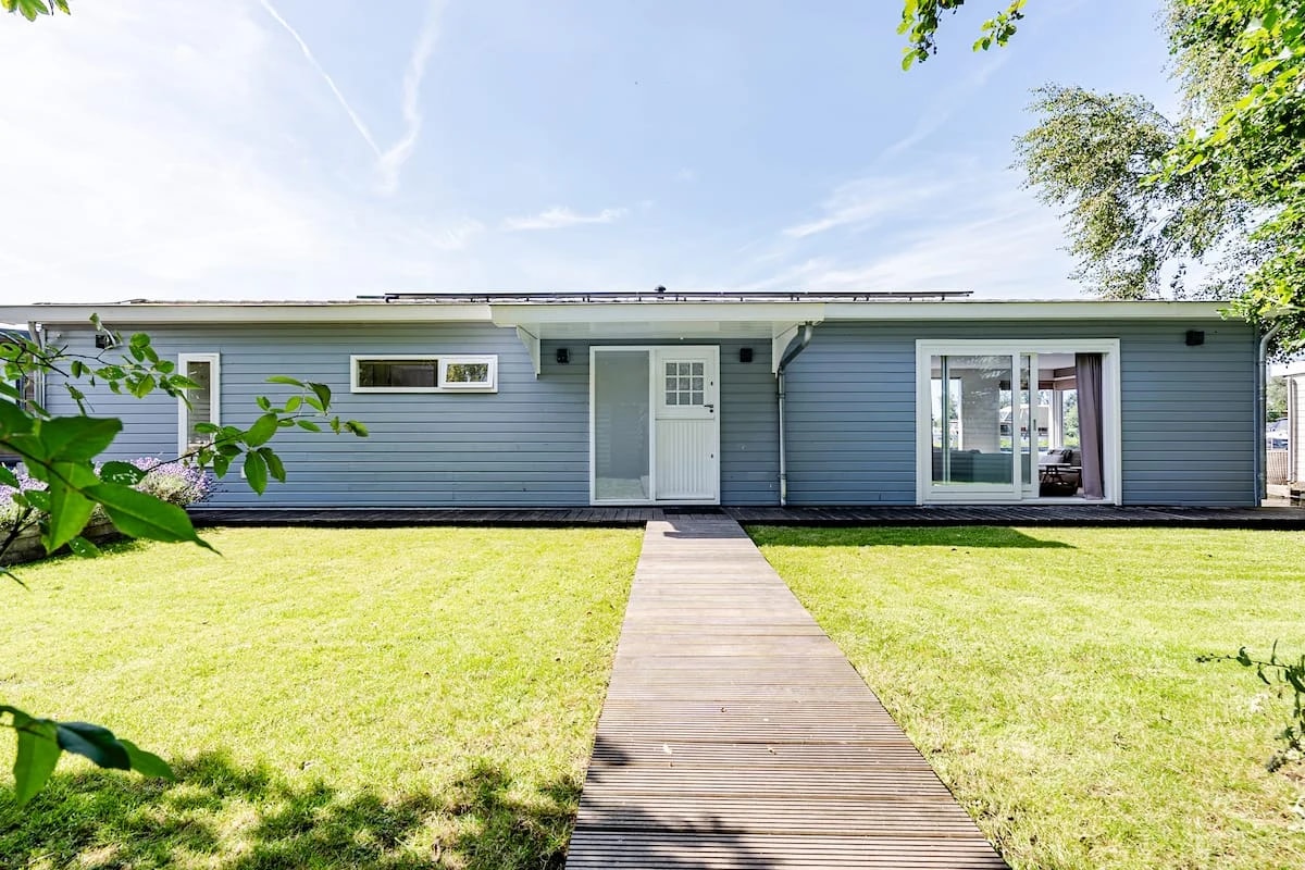 A waterside holiday home with a lawn and jetty